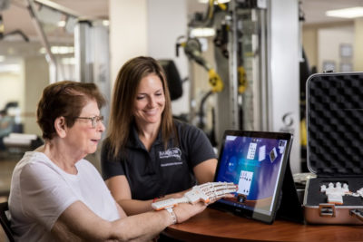 Barrow nurse showing older women monitor