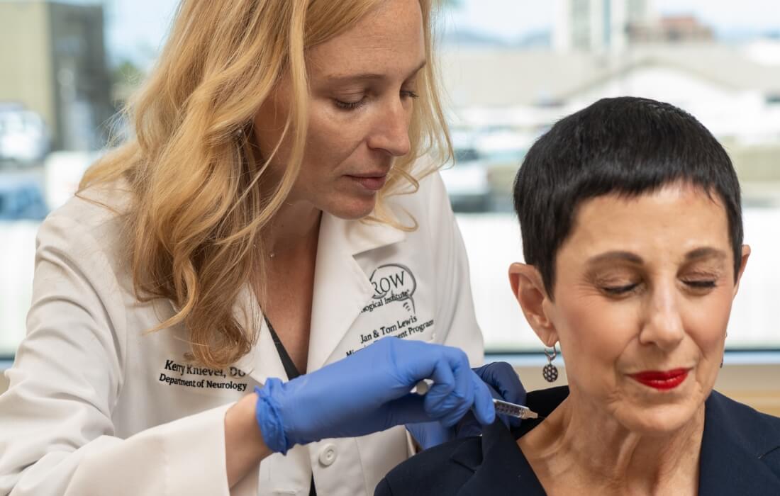 Doctor treating patient for migraine