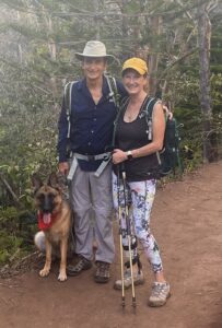 Lynne, her husband, and dog on a hike.