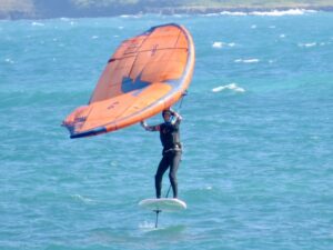Lynne wingfoiling in the ocean.